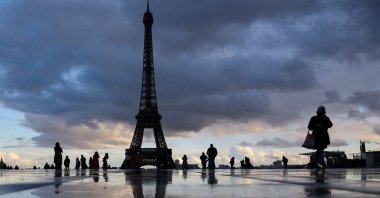 Tourists walk around Trocadero Square near the Eiffel Tower on a cold day in Paris, France, Nov. 19, 2025. (Reuters Photo)