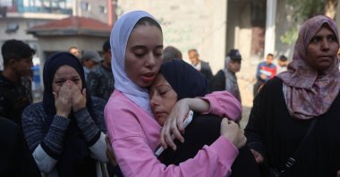 Displaced Palestinian woman Sally Bulbul hugs her mother after her brother was killed in Israeli strikes as they stand outside al-Shifa Hospital in Gaza City, Palestine, Nov. 20, 2025. (AFP Photo)