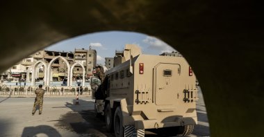 YPG members stand guard at Al-Naeem Square, Raqqa, Syria, Feb. 7, 2022. (AP Photo)