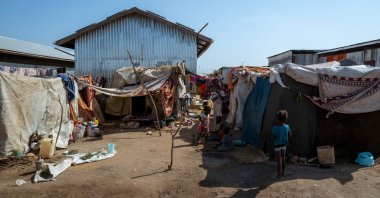 Sudanese refugees gather in front of makeshift shelters at the Renk Transit Center in Renk, South Sudan, Nov. 18, 2025. (AFP Photo)