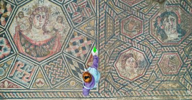 A third-century mosaic uncovered this year shows a woman with a basket of fruit (L), a depiction of a personified Lake Iznik with crab-claw hair ornaments (top right) and geometric motifs, Iznik, Bursa, Türkiye, Nov. 18, 2025. (AA Photo)