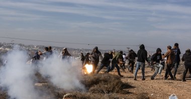 Radical Israeli terrorist group Hilltop Youth run for cover as they clash with Israeli security forces evacuating and demolishing an illegal outpost built near the Jewish settlement of Metzad east of the Palestinian city of Sa’ir in the occupied West Bank, Nov. 17, 2025. (AFP Photo)