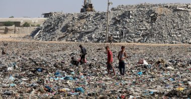 Palestinian children look through garbage near a landfill site in Khan Younis, southern Gaza Strip, Oct. 30, 2025. (Reuters Photo)