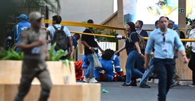 People evacuate the U.N. Climate Change Conference (COP30) negotiation area, Belem, Brazil, Nov. 20, 2025. (EPA Photo)