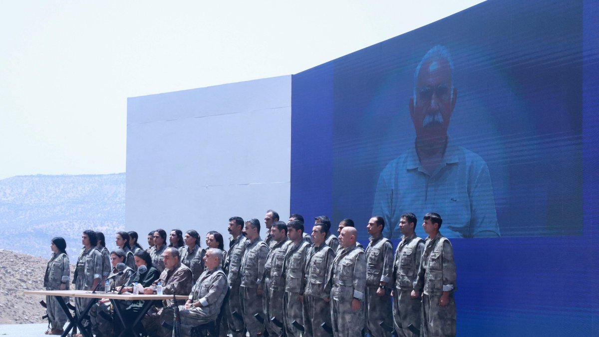 PKK terrorists stand in front of a picture of jailed leader and founder of the PKK Abdullah Öcalan during a disarmament ceremony, Sulaimaniyah, Iraq, July 11, 2025. (AFP Photo)