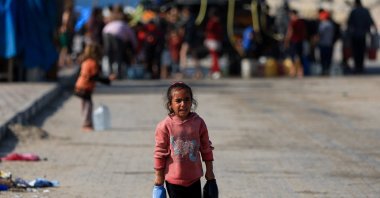 A Palestinian child carries water containers, amid the Gaza cease-fire, Gaza City, Palestine, Nov. 19, 2025. (Reuters Photo)