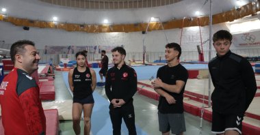 Turkish Gymnastics Federation President and International Gymnastics Federation (FIG) Vice President Suat Çelen speaks to national athletes during their training at the Murat Canbaş Gymnastics Hall, Bolu, Türkiye, Nov. 21, 2025. (AA Photo)