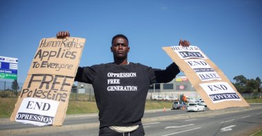 Mqondisi &#039;King Nipho&#039; Ntshangase carries placards, as he protests with his small group on the opening day of the G-20 Summit, outside the Nasrec Expo Centre in Johannesburg, South Africa, Nov. 22, 2025. (Reuters Photo)
