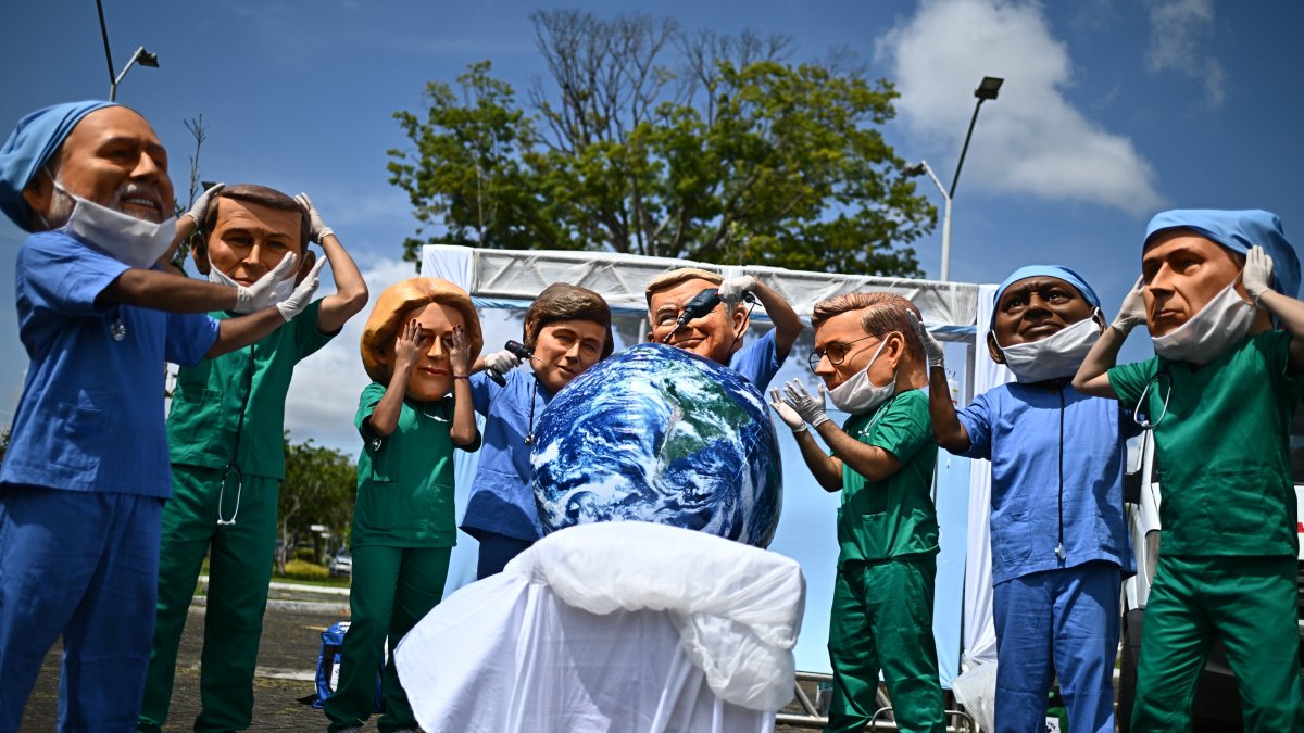 People wearing masks representing world leaders participate in a protest organized by Oxfam, Utinga Park, Belem, Brazil, Nov. 20, 2025. (EPA Photo)