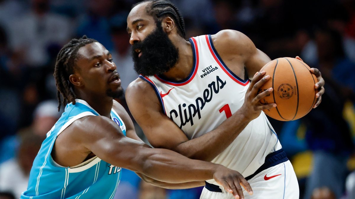 Clippers' James Harden (R) protects the ball from Hornets' Sion James during an NBA game in Charlotte, N.C., Nov. 22, 2025. (AP Photo)