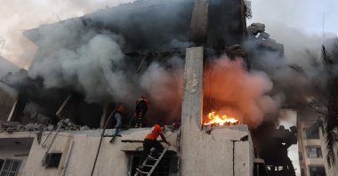 Civil defense teams search a burning home after Israeli airstrikes killed 21 and wounded dozens, Gaza City, Palestine, Nov. 22, 2025. (AFP)