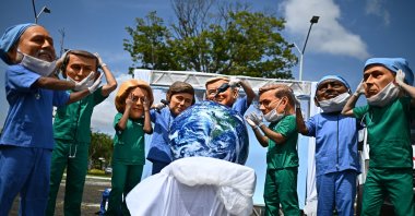 People wearing masks representing world leaders participate in a protest organized by Oxfam, Utinga Park, Belem, Brazil, Nov. 20, 2025. (EPA Photo)