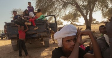 A family of Malian refugees rests after crossing into Mauritania, as they fled the blockade imposed on their city by the JNIM, which tightened its grip on the increasingly weakened Malian military regime, Douankara border point, Fassale, Mauritania, Nov. 4, 2025. (AFP Photo)