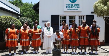 First lady Emine Erdoğan stands in front of the Yunus Emre Institute with cultural representatives during her visit, Johannesburg, South Africa, Nov. 23, 2025. (AA Photo)