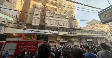 People gather looking at a residential building following an Israeli military strike in the Haret Hreik neighbourhood, of Beirut&amp;#039;s southern suburbs, Lebanon, Nov. 23, 2025. (AFP Photo)