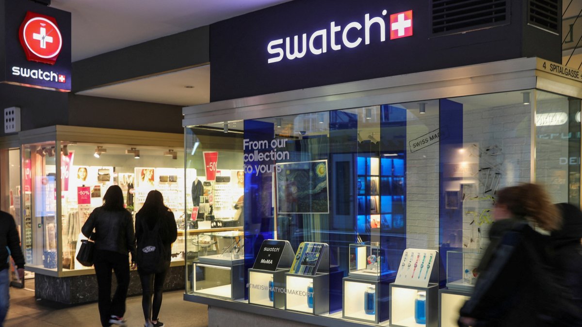 People walk past a shop of Swiss watch manufacturer Swatch, Bern, Switzerland, March 18, 2021. (Reuters Photo)