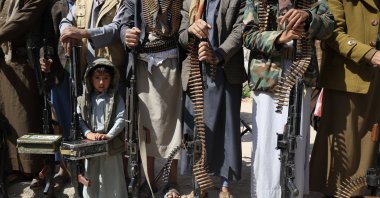 A boy stands among armed tribesmen during an anti-Israel gathering, mobilizing more fighters, Sanaa, Yemen, Nov. 5, 2025. (EPA Photo)