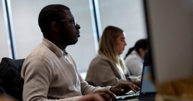Employees work on their computers in the Moore Kingston Smith office in London, U.K., Nov. 13, 2025. (Reuters Photo)