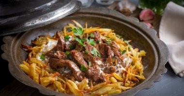 Ranked seventh, Çökertme Kebab from the Milas-Bodrum region features thinly fried potatoes topped with marinated beef or tenderloin, finished with garlic yogurt and a special tomato sauce. (Shutterstock Photo)
