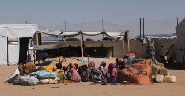 Newly arrived Sudanese refugees from al-Fashir, fleeing ongoing clashes between the paramilitary Rapid Support Forces (RSF) and the Sudanese army, sit on the ground and wait for a place inside the Tine transit camp in eastern Chad, Nov. 23, 2025. (Reuters Photo)