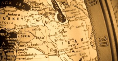 A cross-processed close-up shot of the Middle East region on an old globe, with the longitudinal metal bar on the right of the image. (Getty Images Photo)