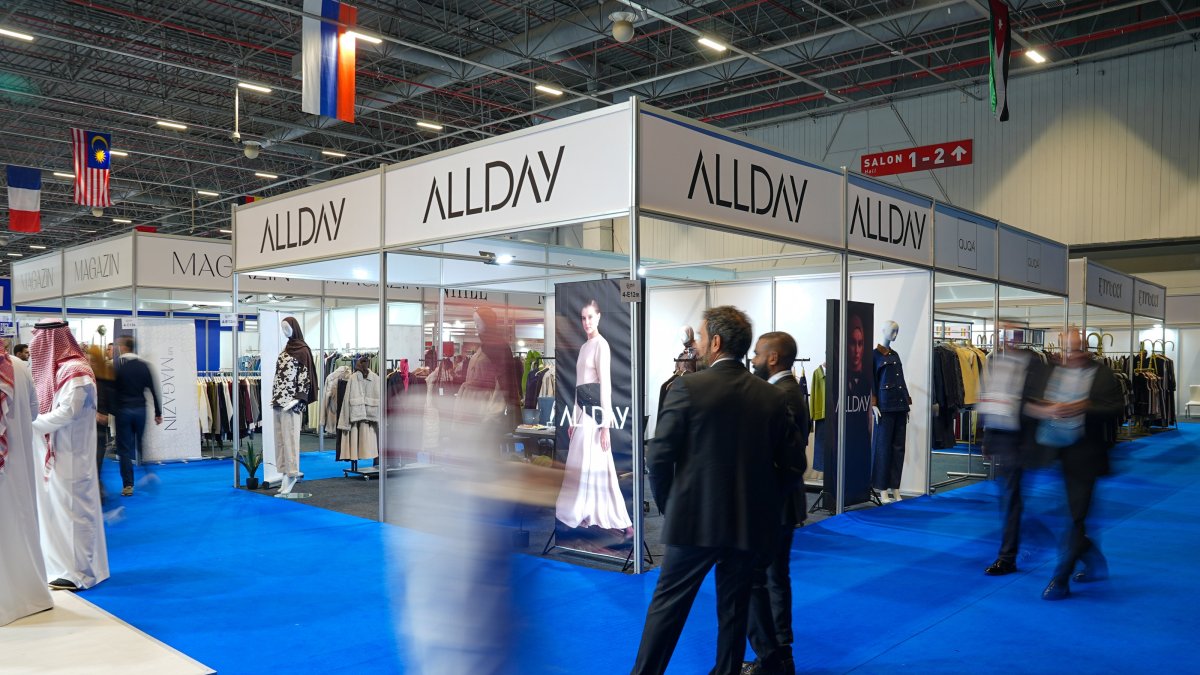 People pass next to a booth at the World Halal Summit and Halal Expo, Istanbul, Türkiye, Nov. 26, 2025. (AA Photo)