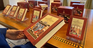 A visitor examines the newly unveiled six-volume “Ottoman Historical Literature” during a conference at the Research Centre for Islamic History, Art and Culture (IRCICA) headquarters in Cağaloğlu, Istanbul, Türkiye, Nov. 25, 2025. (AA Photo)