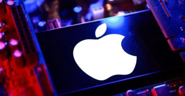An Apple logo and a computer motherboard appear in this illustration created on Aug. 25, 2025. (Reuters File Photo)