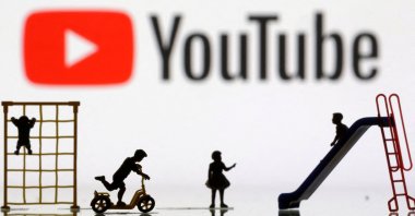 Children playground miniatures are seen in front of displayed Youtube logo in this illustration taken April 4, 2023. (Reuters Photo)