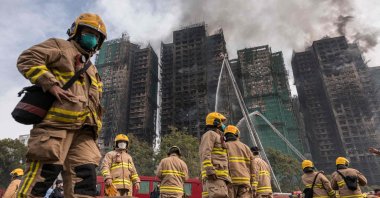 Firemen get ready after a major fire swept through several apartment blocks at the Wang Fuk Court residential estate in Tai Po, Hong Kong, Nov. 27, 2025. (AFP Photo)