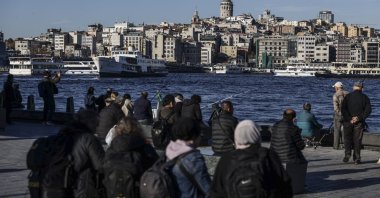 People walk close to the shore, Istanbul, Türkiye, Nov. 25, 2025. (EPA Photo)