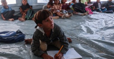 Palestinian pupils attend a class at a school at a displacement camp in the al-Qarara area of Khan Younis, in the southern Gaza Strip, Palestine, Oct. 7, 2025. (AFP Photo)
