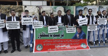 Lawyers and supporters of imprisoned former Pakistani Prime Minister Imran Khan hold placards during a protest against the proposed 26th and 27th constitutional amendments in Karachi, Pakistan, Nov. 7, 2025. (EPA Photo)