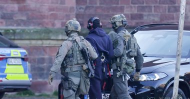 A suspect detained in Italy for the Nord Stream pipelines bombing is led from a helicopter to a motorcade to a court in Karlsruhe, Germany, Nov. 27, 2025. (EPA Photo)