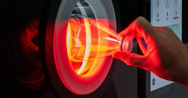 A man inserts a plastic water bottle into the newly unveiled recycling machine, part of the nationwide zero waste campaign, at Parliament, Ankara, Türkiye, Nov. 16, 2025. (AA Photo)