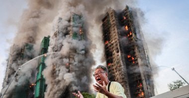 Wong, 71, reacts after saying his wife is trapped inside Wang Fuk Court during a major fire, Tai Po, Hong Kong, Nov. 26, 2025. (Reuters Photo)