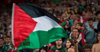 Fans wave Palestinian flags during a friendly match between a selection of Palestinian players and a group of Spanish players from the Basque Country, held to protest Israel&#039;s military actions in Gaza, Bilbao, Spain, Nov. 15, 2025. (AP Photo)