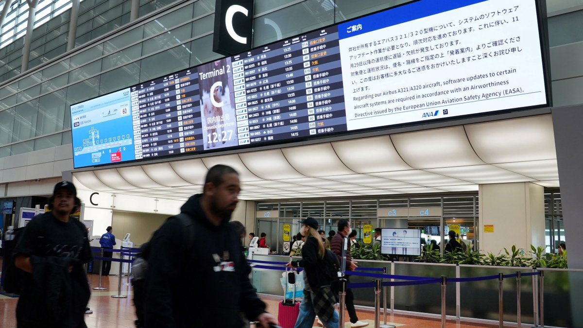 A bulletin board at the All Nippon Airways (ANA) check-in lobby displays a notice that a software upgrade is required for the airline&#039;s Airbus A321/A320 aircraft, which will result in flight delays and cancellations at Haneda Airport, Tokyo, Japan, Nov. 29, 2025. (AFP Photo)