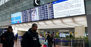A bulletin board at the All Nippon Airways (ANA) check-in lobby displays a notice that a software upgrade is required for the airline&#039;s Airbus A321/A320 aircraft, which will result in flight delays and cancellations at Haneda Airport, Tokyo, Japan, Nov. 29, 2025. (AFP Photo)