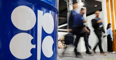 People walk past an installation depicting barrel of oil with the logo of Organization of the Petroleum Exporting Countries (OPEC) during the COP29 United Nations climate change conference in Baku, Azerbaijan Nov. 19, 2024. (Reuters Photo)