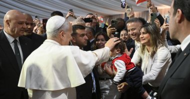 Pope Leo XIV (C) blesses a child while Lebanon President Joseph Aoun (L) looks on during the Pope&#039;s arrival at Beirut International Airport, Beirut, Lebanon, Nov. 30, 2025. (EPA Photo)