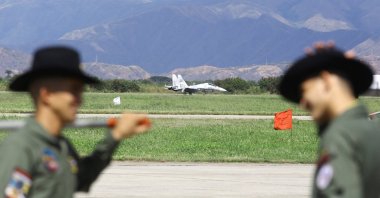 Soldiers talk as a military plane is seen in the background during the Expo Aeronautica Venezuela 2025, after U.S. President Donald Trump&#039;s administration ramps up pressure on President Nicolas Maduro&#039;s government, in Maracay, Venezuela Nov. 29, 2025. (Reuters Photo)