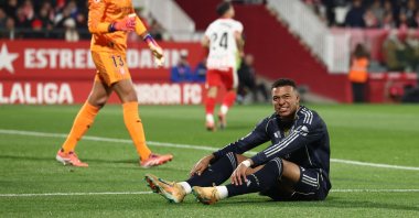 Real Madrid's French forward #10 Kylian Mbappe sits on the field during the Spanish league football match between Girona FC and Real Madrid CF at Montilivi Stadium in Girona on November 30, 2025. (Photo by Josep LAGO / AFP)