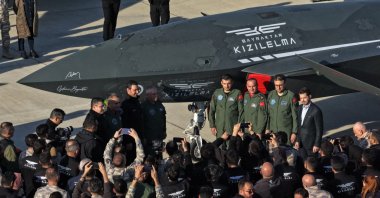 Turkish millitary officials, Aselsan CEO Ahmet Akyol and Baykar Chairperson of the Board and its CTO Selçuk Bayraktar pose next to unmanned combat aircraft Kızılelma, Sinop, northern Türkiye, Nov. 30, 2025. (AA Photo)