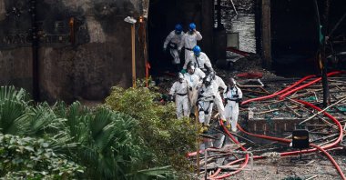 Police officers carry the body of a victim recovered from a fire-damaged residential block at Wang Fuk Court housing complex following a deadly fire, in Tai Po, Hong Kong, China, Dec. 1, 2025. (Reuters Photo)