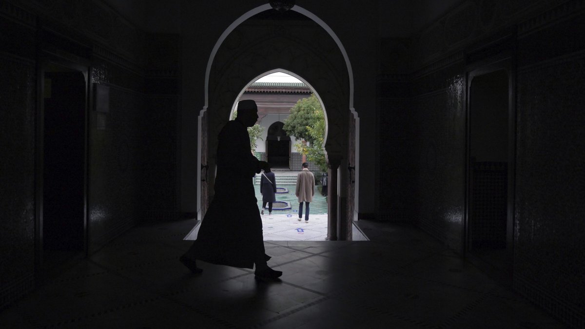 A man walks inside a mosque in Paris, France, Oct. 29, 2020. (AP Photo)