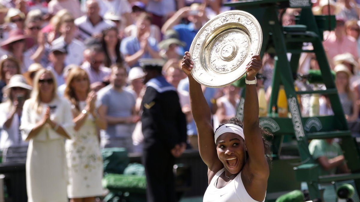 Serena Williams, of the United States, reacts as she holds up the trophy after winning the women's singles final against Garbine Muguruza of Spain, at the All England Lawn Tennis Championships in Wimbledon, London, July 11, 2015. (AP Photo)