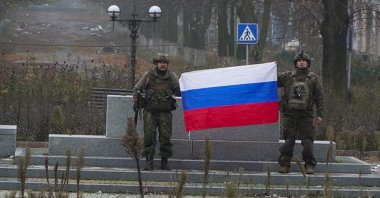 This screengrab shows two soldiers holding up a Russian flag reportedly in the city center of Pokrovsk, eastern Ukraine, Dec. 1, 2025. (AFP Photo)