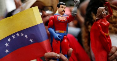 A supporter of Venezuela&#039;s President Nicolas Maduro holds an action figure of &quot;Super Bigote&quot; (Super Mustache), a superhero inspired by the Venezuelan President, in Caracas, Venezuela, Dec. 1, 2025. (Reuters Photo)
