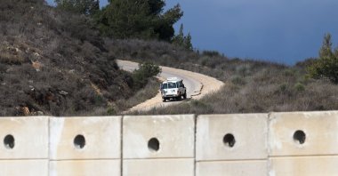 A U.N. vehicle drives near a concrete wall along Lebanon&#039;s southern border which, according to the Lebanese presidency, extends beyond the &quot;Blue Line&quot;, a U.N.-mapped line separating Lebanon from Israel and the Israeli-occupied Golan Heights, as seen from northern Israel, Nov. 16, 2025. (Reuters Photo)